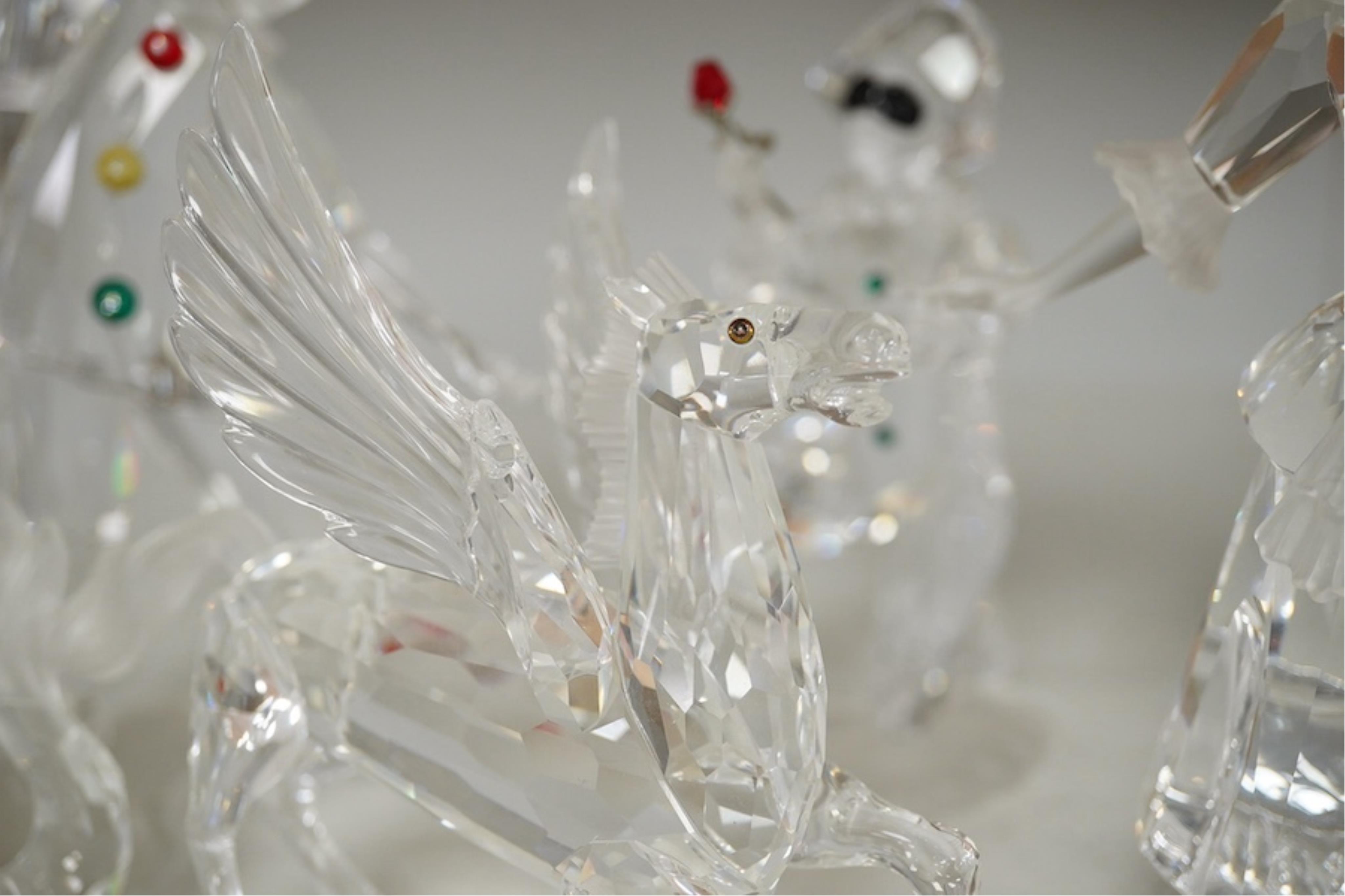 Five Swarovski crystal figures including Masquerade Columbine, Masquerade Harlequin, Masquerade Pierrot, a Chinese Dragon and Pegasus. Condition - good